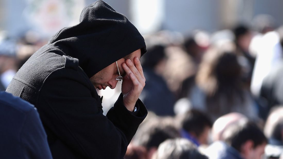 A pilgrim prays as he attends Benedict's final general audience address.