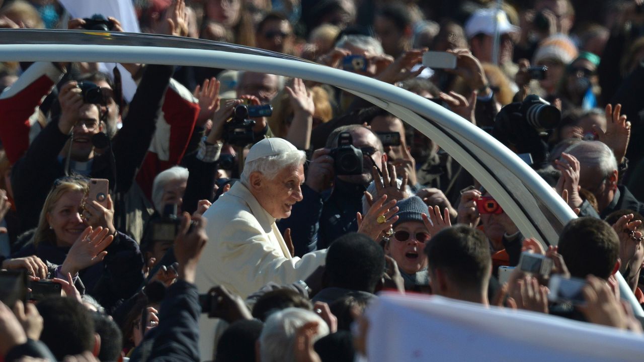 Benedict waves from to the crowd as he arrives at St. Peter's Square.