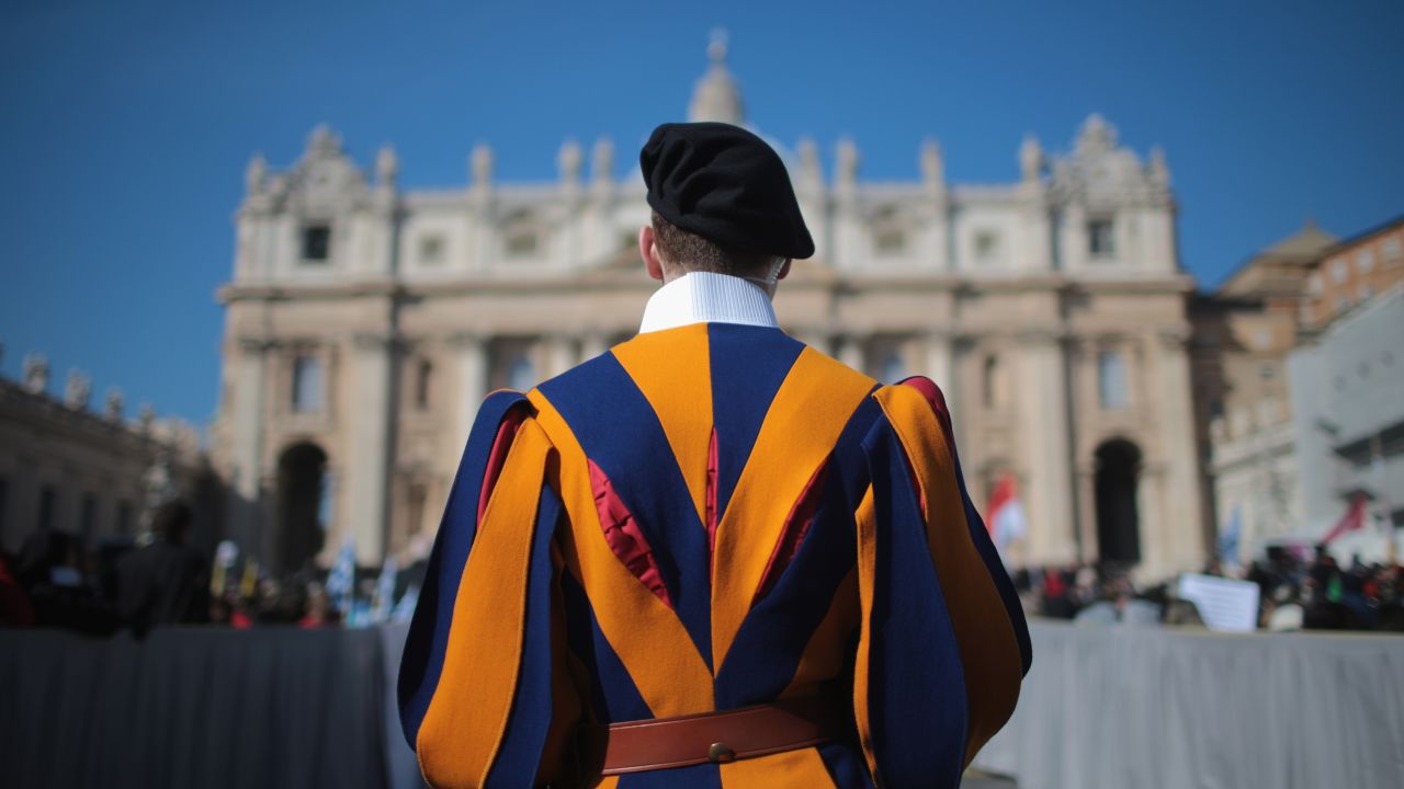 A Swiss guard stands in front of the Vatican.