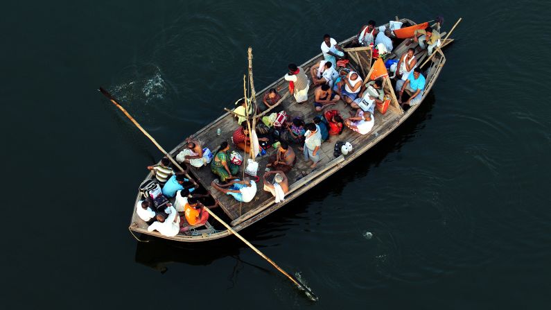 Hindu devotees return by boat after taking a holy dip at Sangam during the Kumbh Mela festival in Allahabad on Wednesday, February 27. 