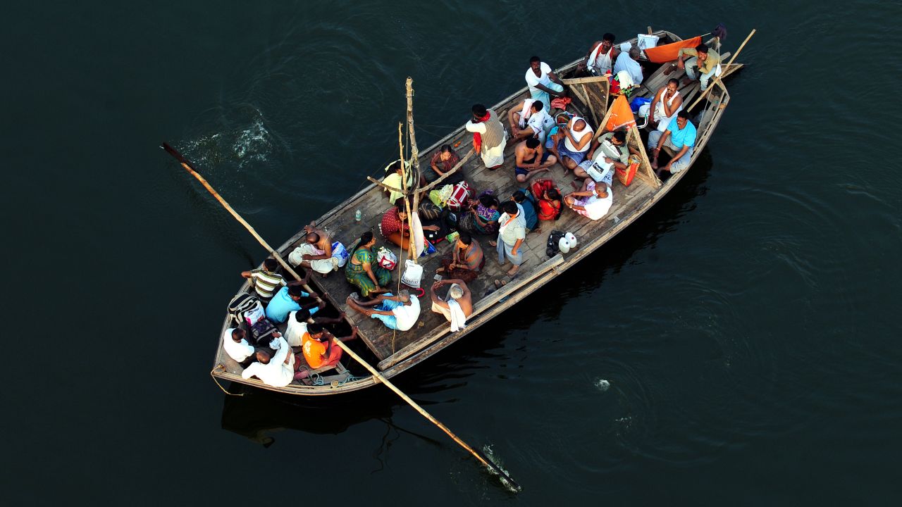 Hindu devotees return by boat after taking a holy dip at Sangam during the Kumbh Mela festival in Allahabad on Wednesday, February 27. 