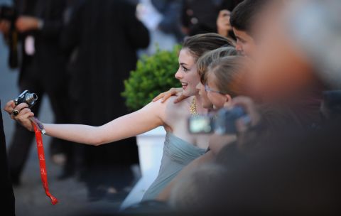 Hathaway stops for a snapshot with fans before the screening of  "Rachel Getting Married" at the Venice International Film Festival in September 2008.