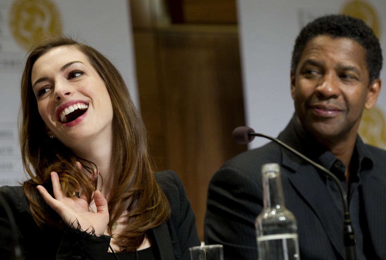 Hathaway and Denzel Washington at a December 2010 press conference in Oslo, Norway, ahead of the Nobel Peace Prize concert. 