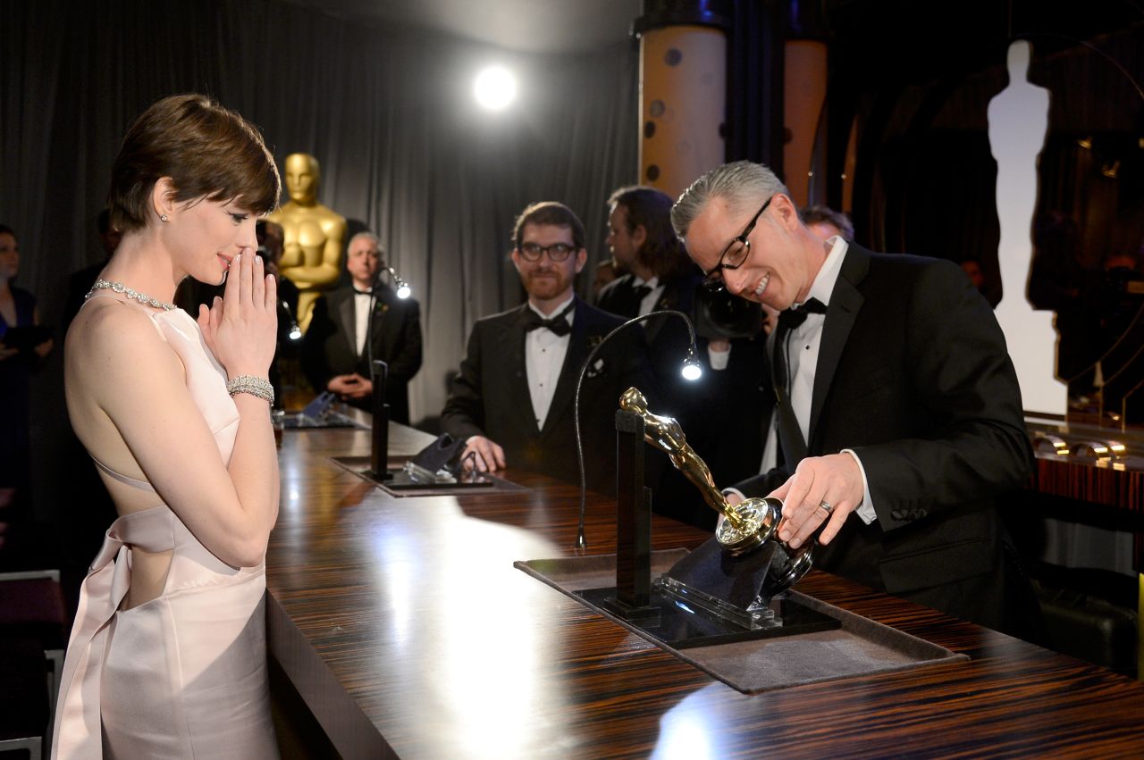 Hathaway gets her Oscar engraved at the Oscars Governors Ball on February 24.