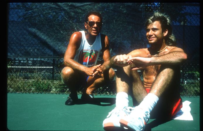 A young Agassi sits with his coach Nick Bollettieri in 1990. Bollettieri was so impressed by Agassi that he gave him a free scholarship at his academy.