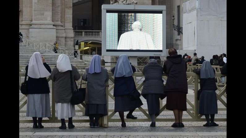 Nuns watch from Vatican City as Pope Benedict XVI leaves the balcony of the papal summer residence in Castel Gandolfo.