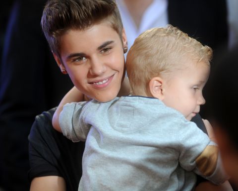 In June 2012, the singer was all smiles as he held baby brother Jaxon at the MuchMusic Video Awards in Toronto.