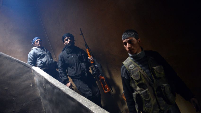 Rebel fighters walks down the stairs to take position to fight against pro-government forces in Izaa district in the Syria's northern city of Aleppo on February 9, 2013. President Bashar al-Assad reshuffled his cabinet Saturday as regime warplanes raided rebel areas in a bid to end the stalemate in Syria's deadly civil war and hopes for a political solution appeared to founder. AFP PHOTO/AAMIR QURESHI (Photo credit should read AAMIR QURESHI/AFP/Getty Images)
