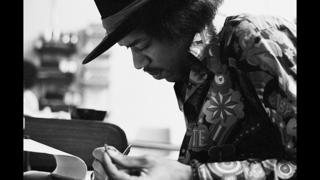 <strong>Hendrix at the Record Plant in 1968:</strong><br />"Jimi had the habit of making the final draft of a song he was working on just before he went into the booth to record the vocal. This photo shows a smiling Jimi putting the final touches to 'Gypsy Eyes' from the many notes he kept with him usually written on hotel stationery, napkins or matchbook covers. These would be assembled on a yellow legal pad just prior to singing the final vocal. An interesting observation is that he wrote right-handed even though he played lefty."  --<em> Eddie Kramer</em>