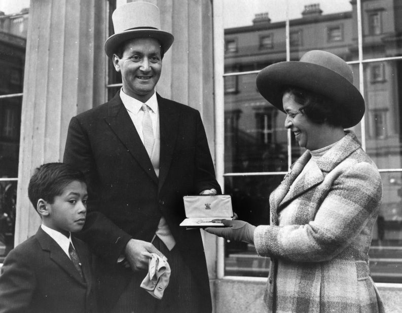 D'Oliveira, standing with wife Naomi and son Damian,  was awarded the OBE by Queen Elizabeth II on October 29, 1969 at Buckingham Palace. He was also honored by the Royal Family in 2005 where he was awarded a CBE.
