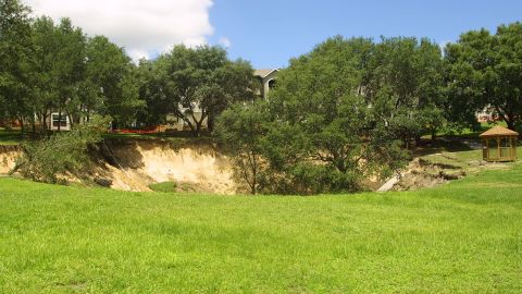 In Orlando, a sinkhole 150 feet wide and 60 feet deep swallowed trees, pipelines and a section of sidewalk near an apartment building in June 2002.