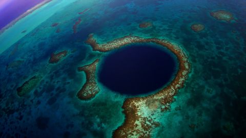 "The Great Blue Hole" is the name of a massive underwater sinkhole off the coast of Belize. The deeper you go, the clearer the water becomes, revealing amazing stalactites and limestone.