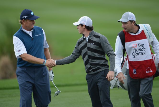 McIlroy shakes hands with British Open champion Ernie Els before making his exit from the Honda Classic in Florida.