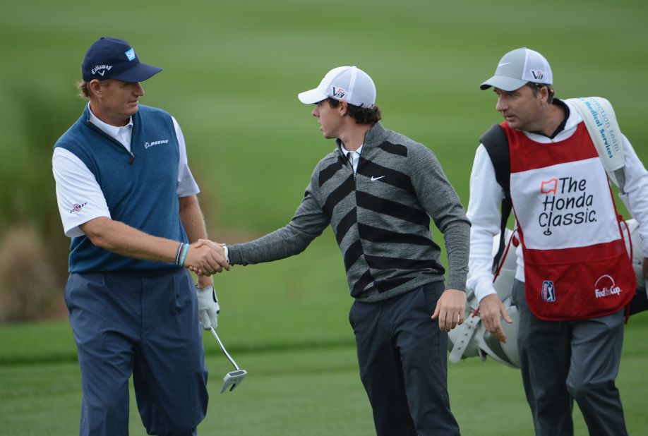 McIlroy shakes hands with British Open champion Ernie Els before making his exit from the Honda Classic in Florida.