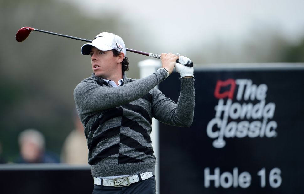 McIlroy looks pensive as he tees off on the 16th where he ran up a triple bogey seven to derail his Honda Classic title defense.