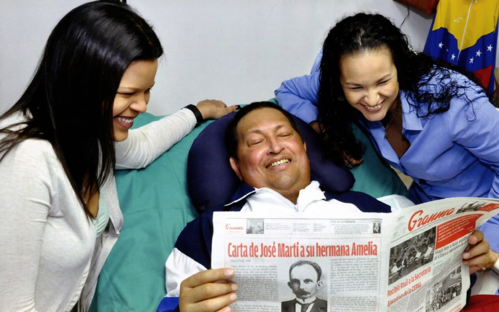 A handout picture released by the Venezuelan presidential press office on Friday, February 15, 2013, shows Chavez surrounded by his daughters and holding the February 14 edition of the official Cuban newspaper Granma at a hospital in Havana, Cuba.