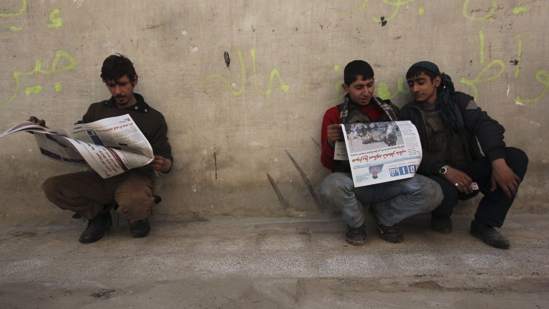 Residents read Shaam News newspapers published by the Free Syrian Army in Aleppo on March 2.