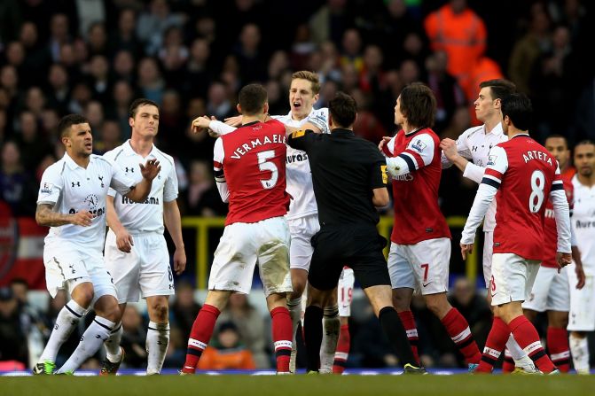 Tenisons threatened to boil over as Tottenham captain Michael Dawson and Arsenal skipper Thomas Vermaelen reacted angrily after the visiting team decided not to kick the ball out of play for Emmanuel Adebayor to receive treatment. 