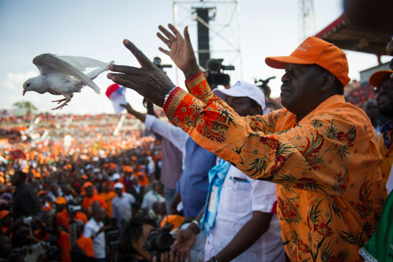 Kenyan Prime Minister and presidential candidate Raila Odinga releases a dove at a rally in Nyayo Stadium in Nairobi on March 2, 2013, on the last day of campaigning, 48 hours ahead of presidential, gubernatorial and senatorial elections.