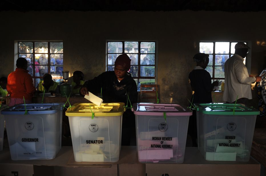 A voter puts a ballot paper into the senatorial box as voting kicked off in Kenya on March 4, 2013 in the country's western province in Kakamega. Long lines of Kenyans queued from far before dawn to vote Monday in critical elections, the first since violent polls five years ago, with five policemen killed in an ambush in Mombasa hours before polling started.