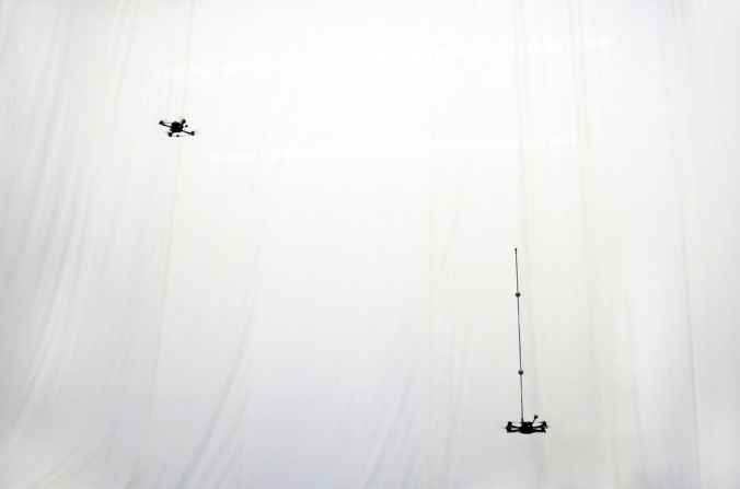 At the Flying Machine Arena, two quadrocopters prepare to perform ...
