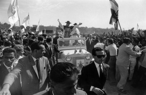 1964: During a visit to the John Bosco School in India, Pope Paul VI drives through the crowds with a convoy of bodyguards.