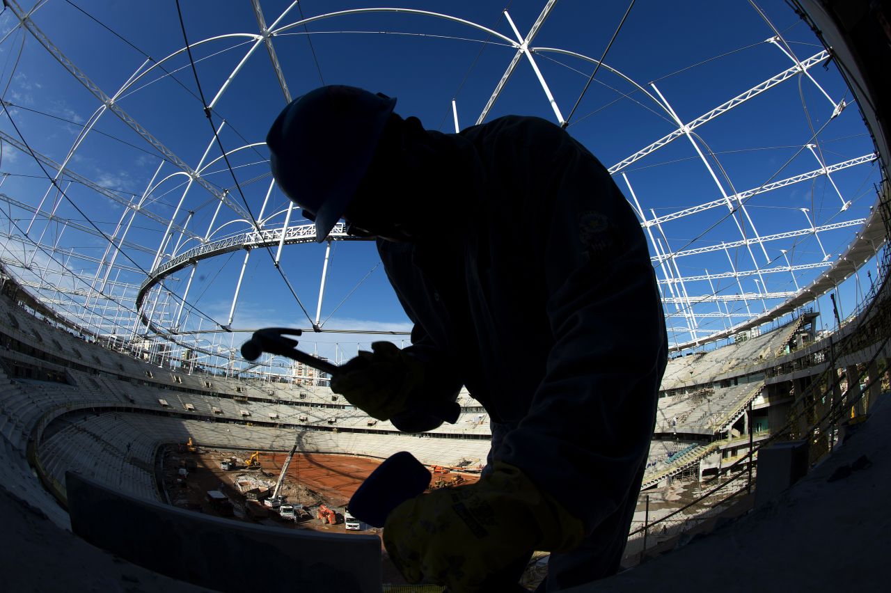 A worker swings a hammer inside 'Arena Fonte Nova' stadium in Salvador de Bahia, Brazil on December 6, 2012 before next June's eight-nation Confederations Cup.