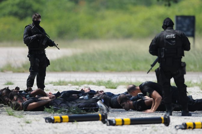 Police commandos from an anti-kidnapping unit, arrest and control a group of 'terrorists' during a drill at the Tom Jobim International Airport in Rio de Janeiro, Brazil, on January 13, 2012.