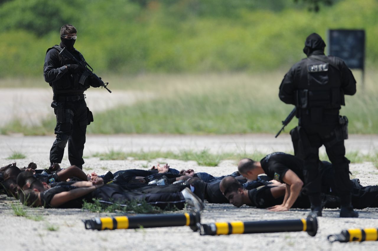 Police commandos from an anti-kidnapping unit, arrest and control a group of 'terrorists' during a drill at the Tom Jobim International Airport in Rio de Janeiro, Brazil, on January 13, 2012.