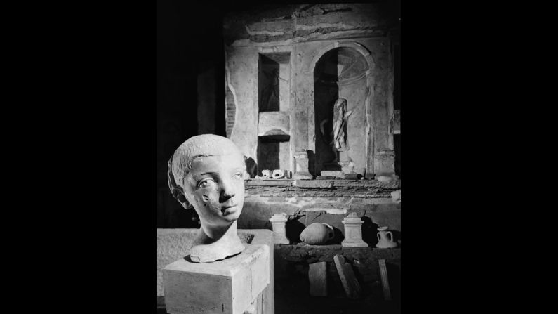 The bust of a statue is seen during the excavating process.