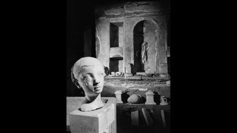 The bust of a statue is seen during the excavating process.