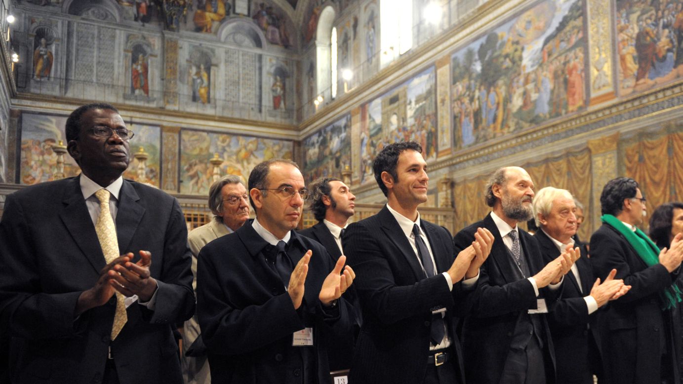 Artists applaud at the end of a meeting with Pope Benedict XVI at the Sistine Chapel on November 21, 2009. About 250 artists accepted an invitation to discuss renewing the alliance of art and the church while encouraging the artists to infuse spirituality into their works.