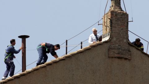 Vatican workers place a chimney pot on the roof of the Sistine Chapel for the conclave in April 2005 that ultimately elected Pope Benedict XVI. Onlookers focus on the chimney for smoke signals that indicate whether a new pope has been elected. Black signals no election yet; white means there's a new pope.