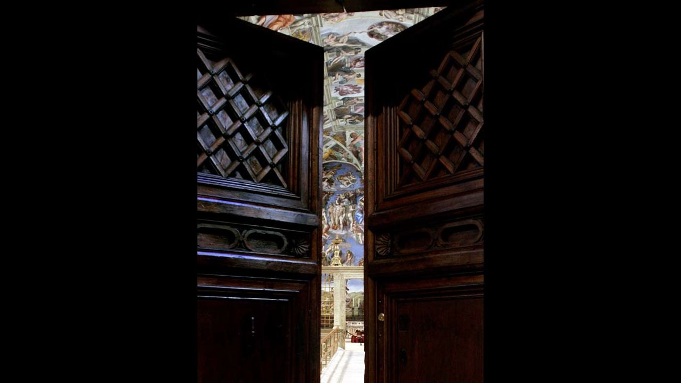 Michelangelo's "The Last Judgment" is seen through the Sistine Chapel doors on April 16, 2005.