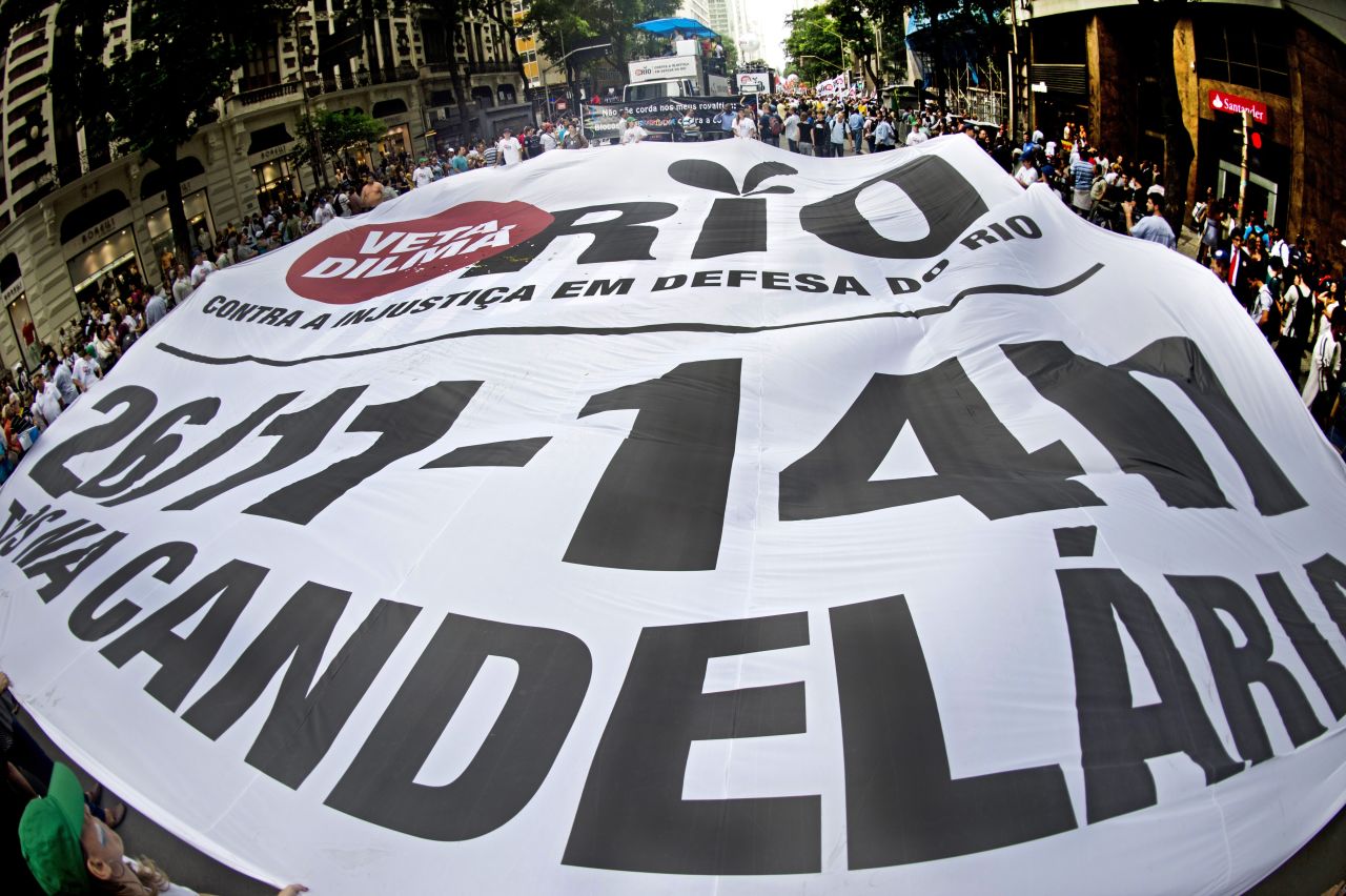 People hold a huge banner during a demonstration demanding that Brazilian President Dilma Roussef veto a bill that would redistribute oil royalties in favor of non-oil producing states.