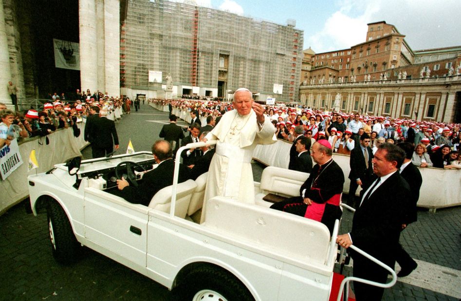 Pope John Paul II salutes the crowd as he arrives for his weekly address in Vatican City on May 27, 1998.