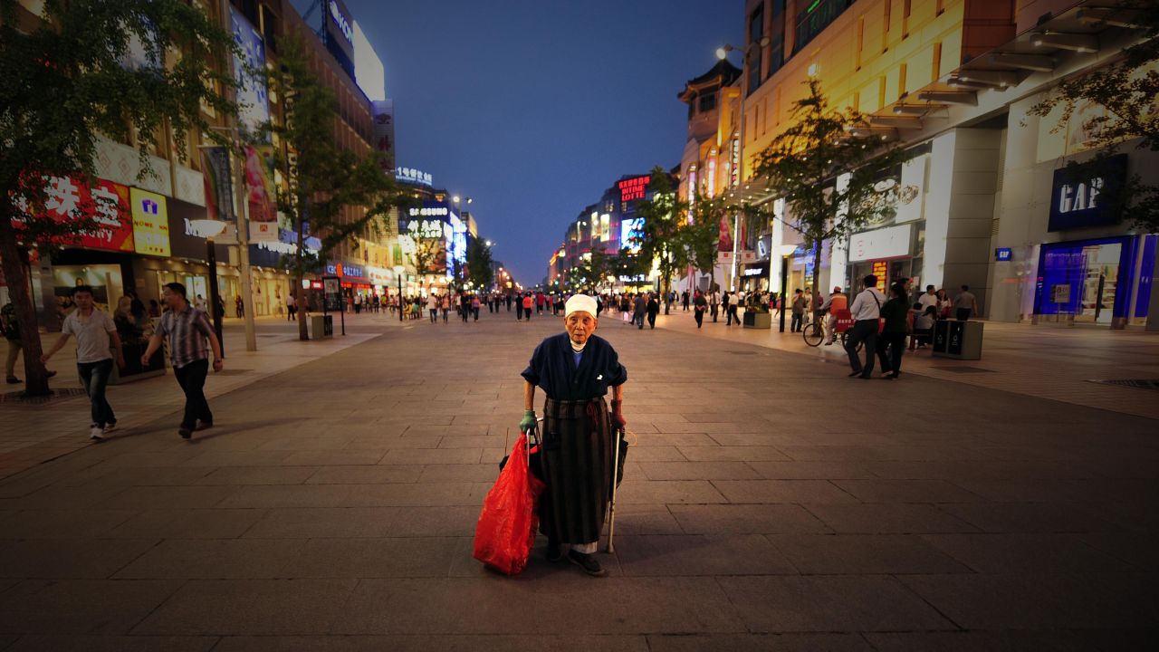A file image of 90-year-old Li Xiuying collecting bottles and cardboard boxes to sell for recycling in Beijing, 2010.