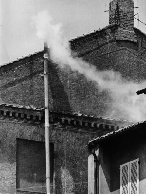 White smoke emanates from the Sistine Chapel chimney to indicate the election of a new pope in 1963.