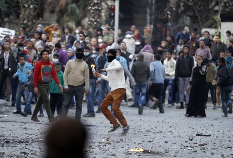 The mass demonstrations in Cairo's Tahrir Square have often been violent. In this picture, taken on January 30, 2013, a masked protester readies to throw a molotov cocktail.