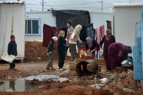 Syrian children gather around women washing in the Zaatari refugee camp in January 2013.