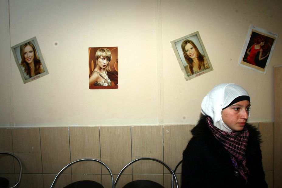 In November 2012, a Syrian refugee waits at a hairdresser's shop inside the Oncupinar camp in Kilis, Turkey.