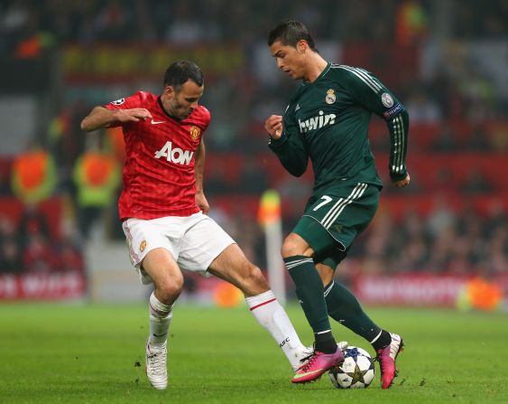 Manchester United's veteran star Ryan Giggs battles for the ball with Ronaldo in a midfield tussle. 