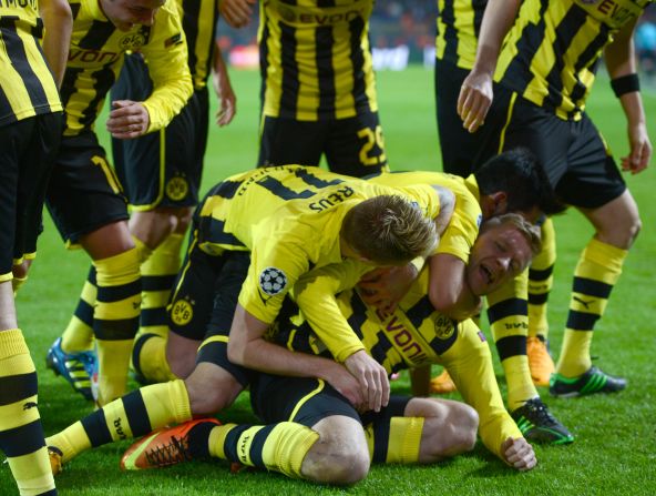 Dortmund's Polish midfielder Jakub Blaszczykowski is mobbed after scoring during his side's 3-0 win over Shakhtar Donetsk.