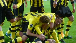 Dortmund's Polish midfielder Jakub Blaszczykowski is mobbed after scoring during his side's 3-0 win over Shakhtar Donetsk.