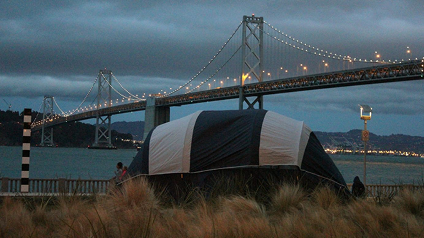A tent set up in front of the Bay Bridge before the lighting show. 