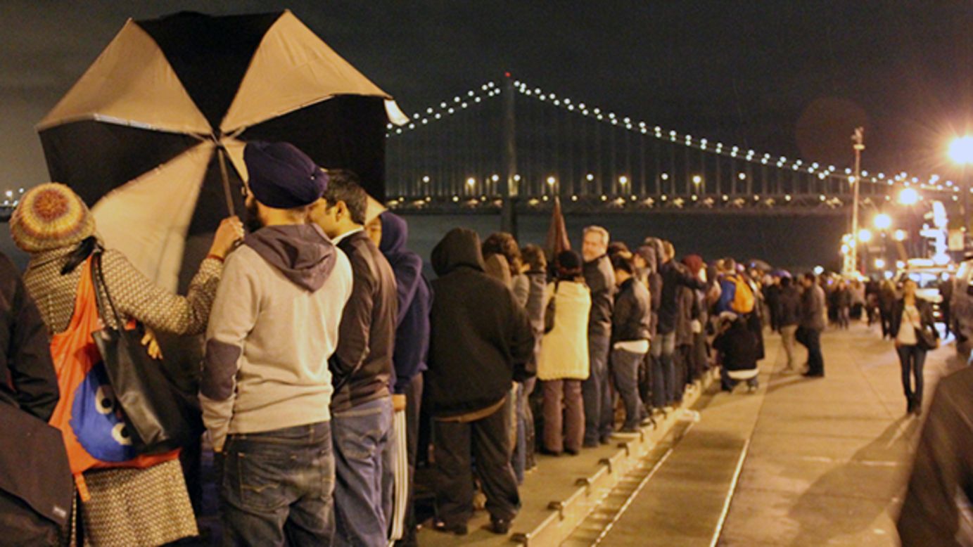 People lined up along the Embarcadero in San Francisco ahead of the light show.
