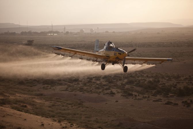 A light plane sprays pesticides in Kmehin on Wednesday.