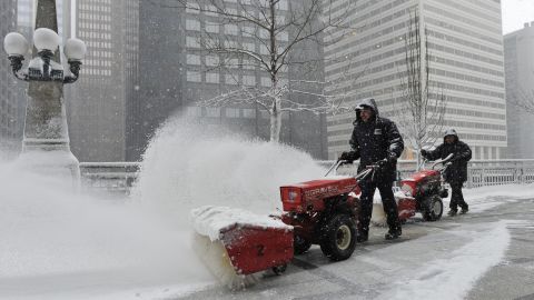 Arturo Garcia, left, and Ricardo Perez clear snow from Chicago's Riverside Plaza on March 5.