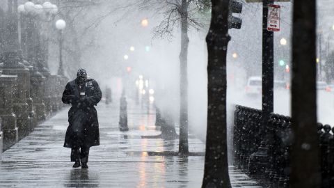 A man walks on 17th Street as snow and rain begin to fall on March 6 in Washington.