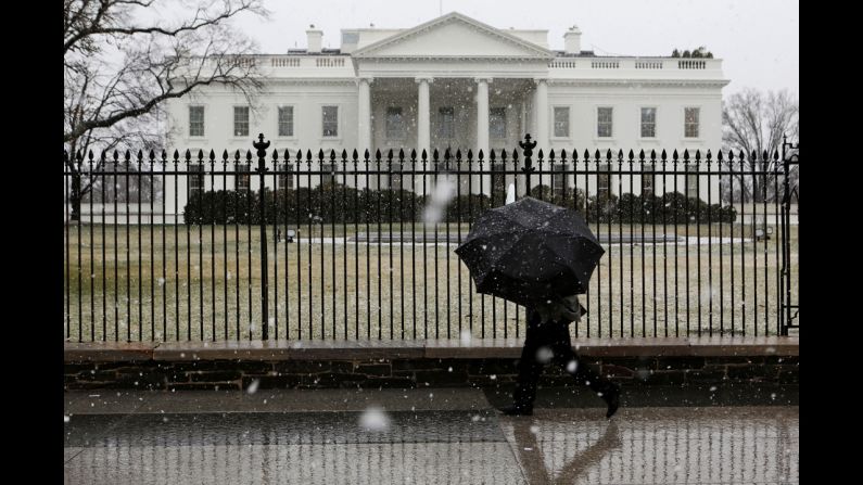 A man walks in front of the White House as snow and rain hit the Washington area on March 6.